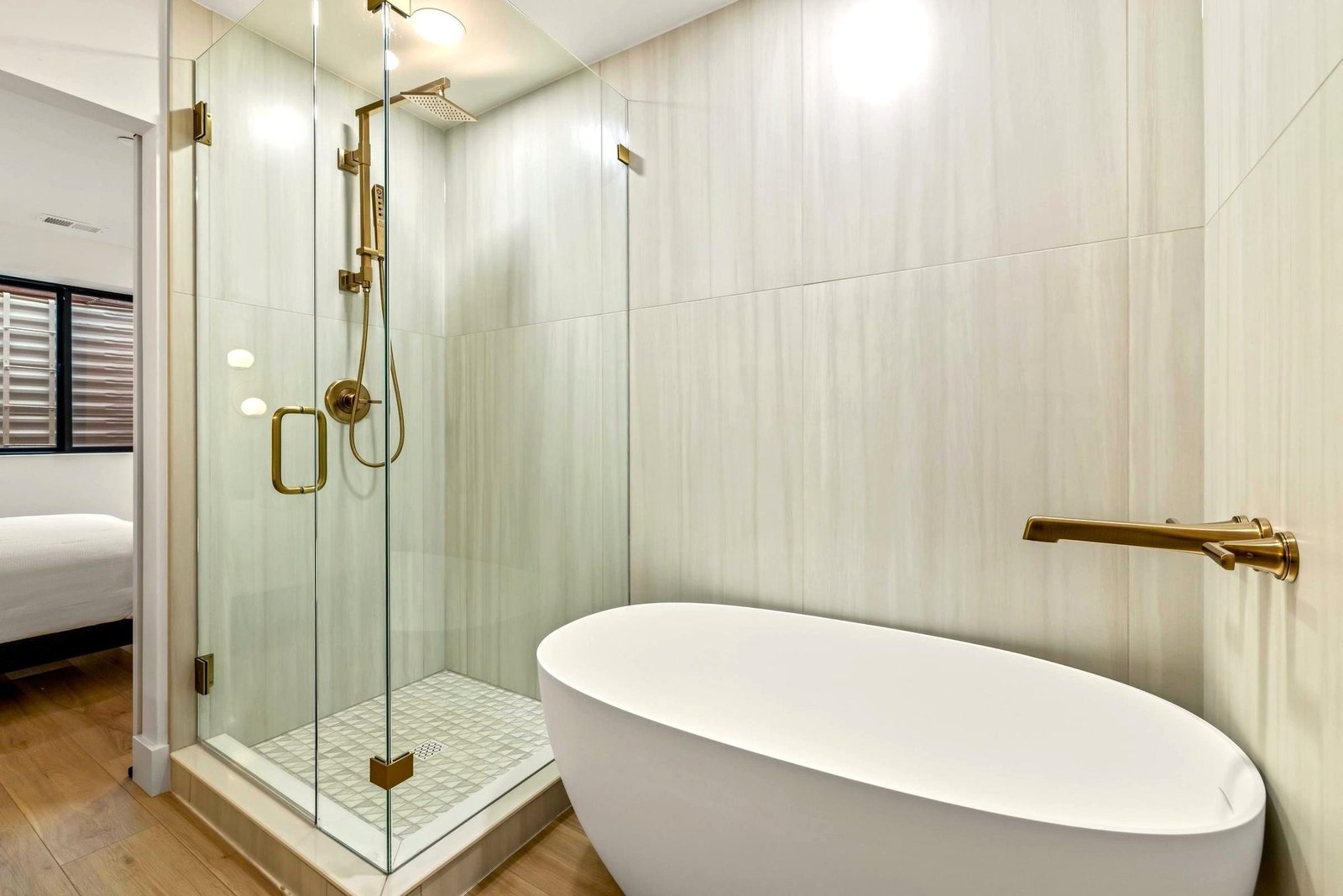 Bathroom with a bathtub and glass-enclosed shower