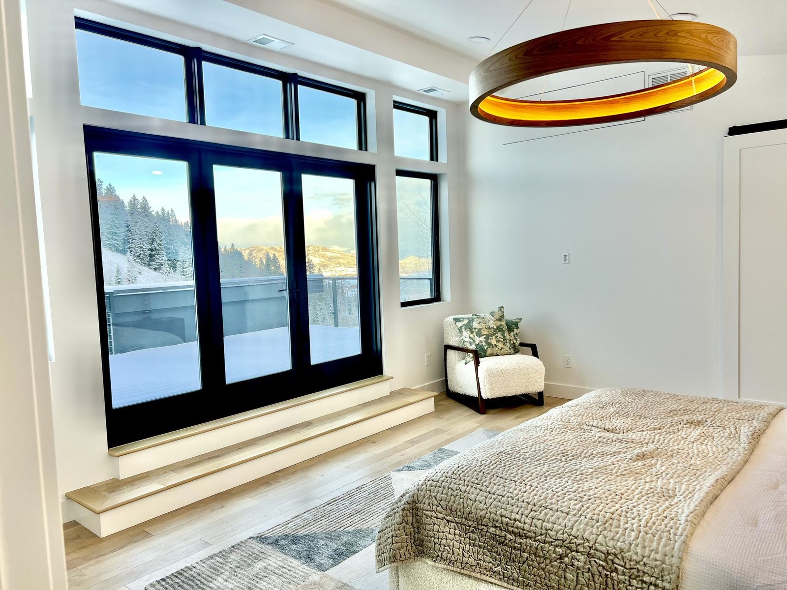 Bedroom opening toward a deck and mountain view